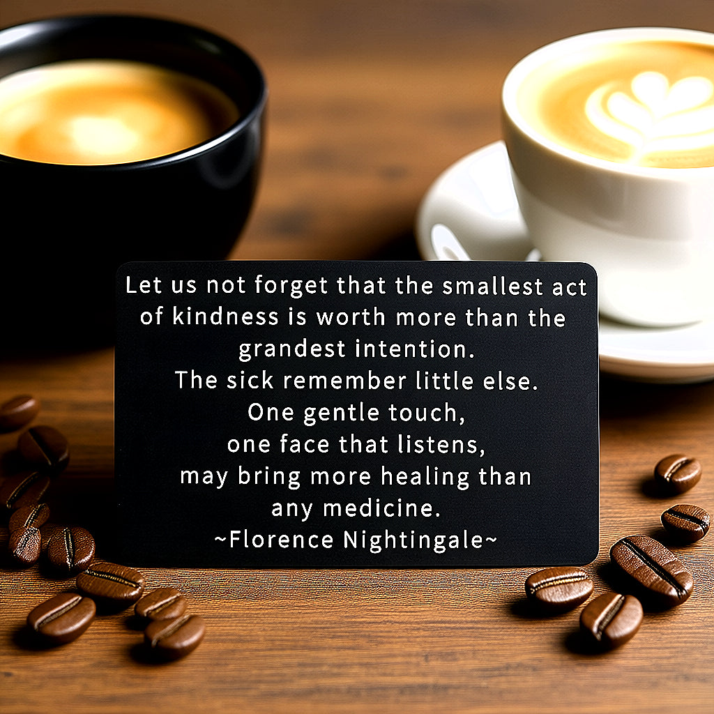 Black engraved metal wallet card with Florence Nightingale's quote on kindness and healing, on a wooden table with coffee beans and two cups of coffee.