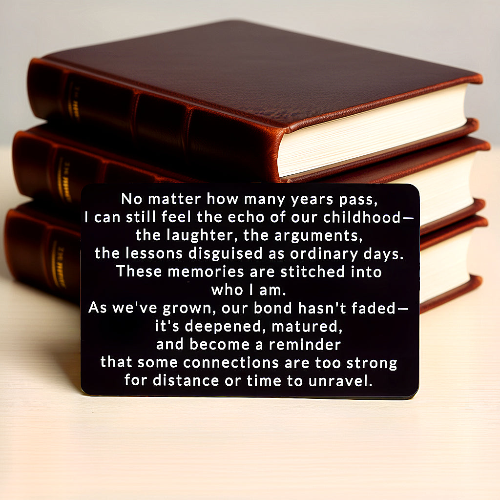 Black engraved metal wallet card reading 'Our Bond Deepened Beyond Childhood' with three leather-bound books behind it.