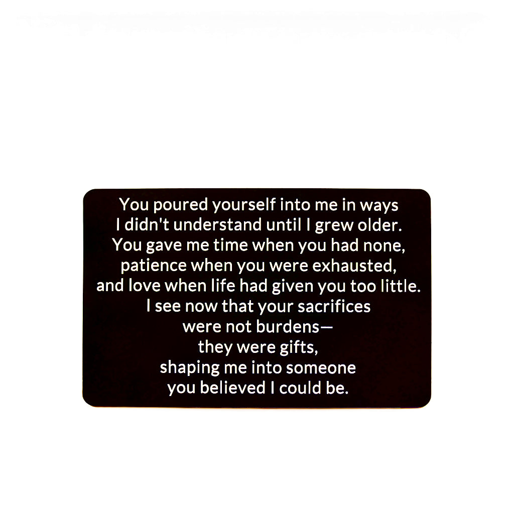 Black engraved metal wallet card reading 'Your Sacrifices Were Gifts' on a white background.